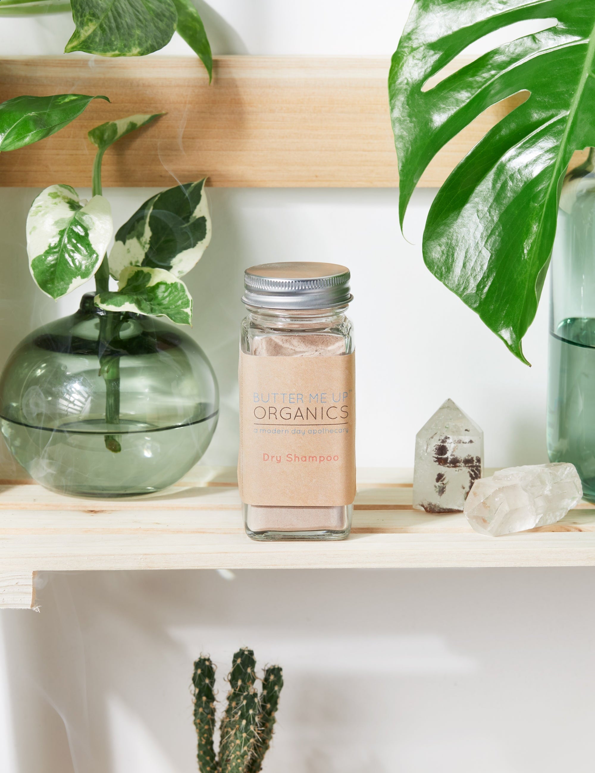 Natural Organic Dry Shampoo in cute tin packaging with aesthetic leaf crystal shelf backdrop