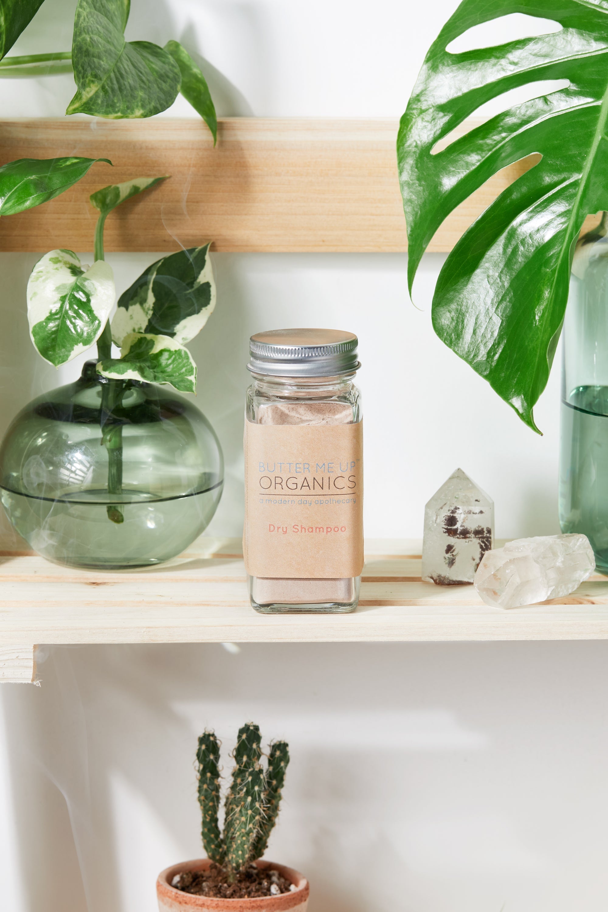 Natural Organic Dry Shampoo in cute tin packaging with aesthetic leaf crystal shelf backdrop