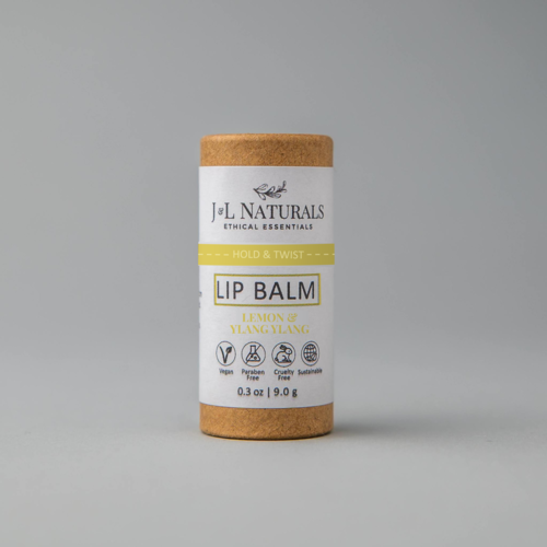 lip balm in brown and yellow packaging in white backdrop zoomed out