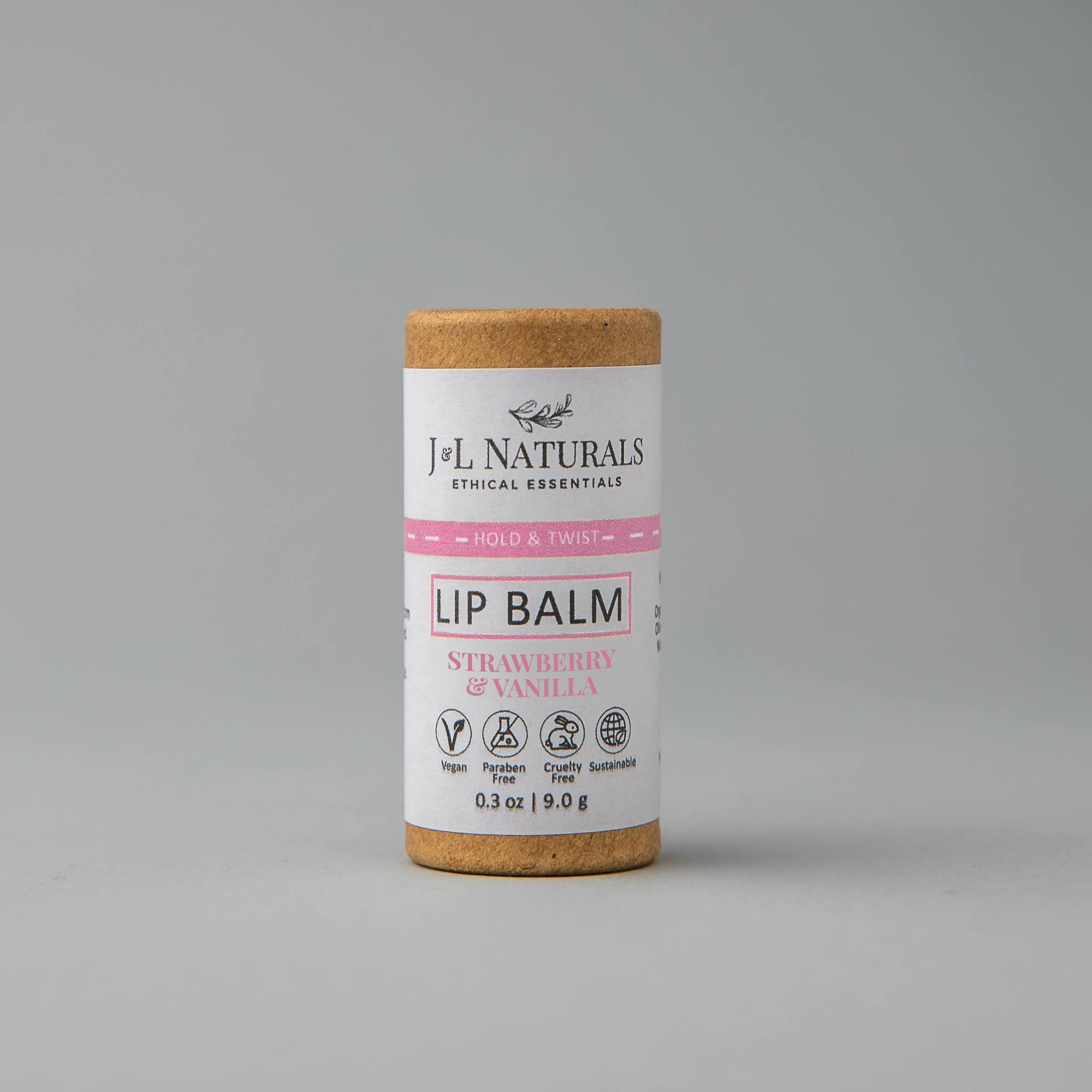 front close shot of lip balm in brown and pink packaging in white backdrop 