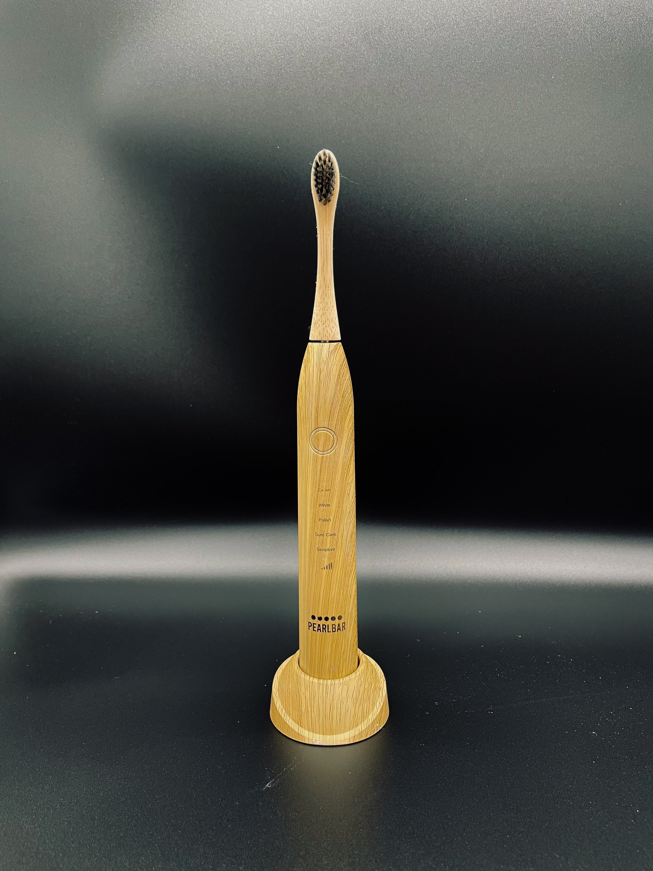 eco friendly bamboo electric toothbrush in a black background