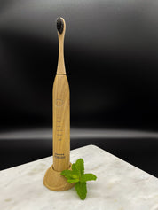 eco friendly bamboo electric toothbrush with a black background 