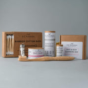 essentials kit with face and skin products in brown and pink packaging with whitish grey background