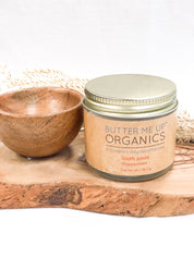 close up shot of closed toothpaste powder in glass jar tin accompanied with wooden empty bowl for aesthetic in white backdrop