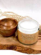 close up shot of opened toothpaste powder in glass jar tin accompanied with wooden empty bowl for aesthetic in white backdrop