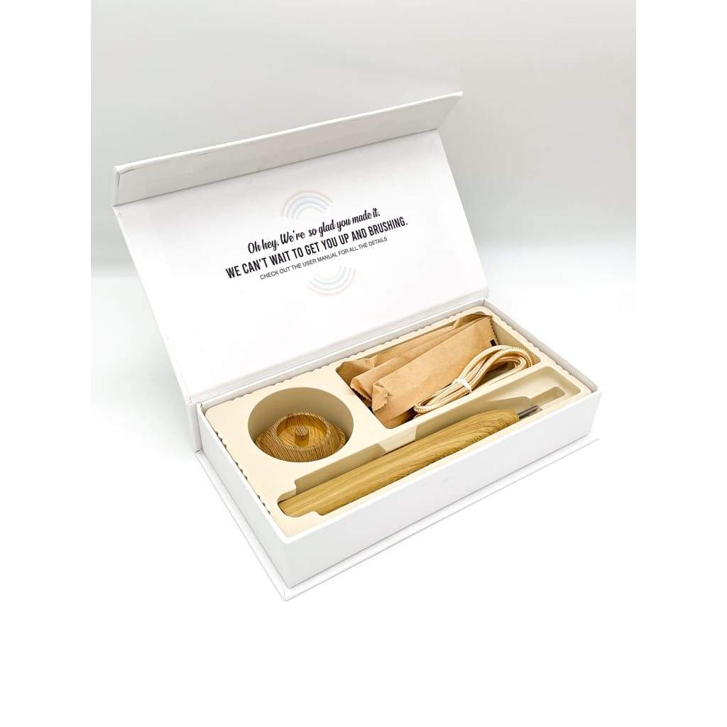 eco friendly bamboo electric toothbrush with the box open which also shows the charger in a white background